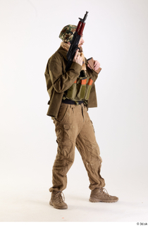 Andrew Elliott Insurgent Holding Machine Gun holding gun standing whole…
